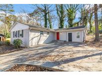 Newly renovated ranch home with a red door and attached garage at 2307 Cresta Dr, Decatur, GA 30032