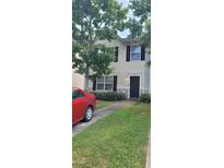 Two-story house with a landscaped lawn and a black door at 1771 Fielding Way, Hampton, GA 30228