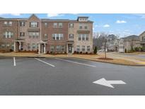 Brick townhome with 3 levels, front entrance, and landscaping at 3420 Reagan Way # 89, Lawrenceville, GA 30044