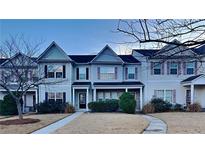 Inviting 2-story townhome with charming facade and landscaping at 4146 Shoals Pt, Union City, GA 30291