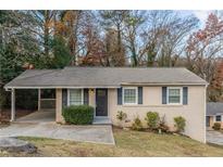 Brick ranch home with carport and landscaped yard at 3597 Fairlane Nw Dr, Atlanta, GA 30331