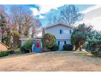 Two-story house with gray siding, red door, and landscaping at 4557 Greenleaf Sw Cir, Atlanta, GA 30331