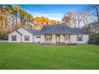 Ranch style home with front porch and large yard at 125 S Hampton Rd, Hampton, GA 30228