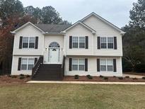 Two story house with brown accents and landscaping at 360 Chestnut Dr, Covington, GA 30016