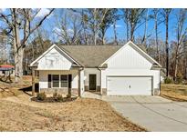 Newly built home with white siding, stone accents, and a two-car garage at 391 Mulberry Rock Rd, Temple, GA 30179