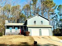 Newly painted two-story house with a two-car garage and a porch at 3945 Peninsula Ct, Lawrenceville, GA 30044