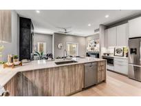 Modern kitchen with island, stainless steel appliances, and light wood cabinets at 1099 North Ne Ave # 13, Atlanta, GA 30307