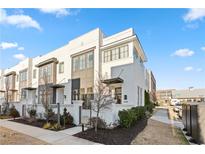 Modern white brick home with gray accents and landscaped yard at 6750 Avis Walk, Alpharetta, GA 30005