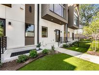 Modern townhome with white and brown exterior, landscaped lawn, and private entrance at 1099 North Ne Ave # 11, Atlanta, GA 30307