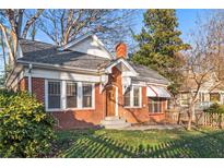 Brick home with a charming front porch and well-maintained lawn at 1015 Deckner Sw Ave, Atlanta, GA 30310