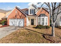 Brick two-story house with attached garage and landscaping at 6469 Alder Ln, Norcross, GA 30093