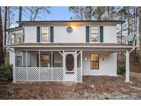 Two-story house with screened porch and white siding at 166 Pebble Path, Douglasville, GA 30134