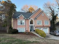 Two-story house with peach stucco siding, two-car garage, and landscaped yard at , Acworth, GA 30101