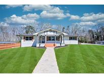 Newly renovated ranch home with modern exterior and spacious lawn at 310 Ferndale Sw Dr, Mableton, GA 30126