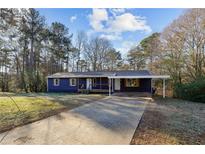 Ranch style home with blue exterior, driveway, and landscaping at 8 Regency Se Way, Mableton, GA 30126