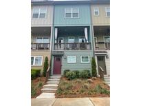 Three-story townhome with a charming front porch and landscaping at 732 Fond Ln, Atlanta, GA 30315