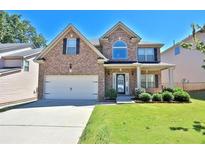 Brick two-story house with a large yard and attached two-car garage at 2632 Gloster Mill Dr, Lawrenceville, GA 30044