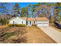 Ranch style home with 2-car garage and mature landscaping at 5711 Rally Ct, Rex, GA 30273