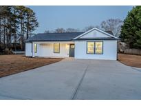 Charming one-story home with gray door and new landscaping at 2605 Bobo Road, Dallas, GA 30157