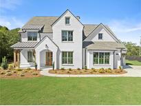 Two-story white brick home with gray roof, landscaping, and a long driveway at 324 Mont Harmony Sw Rd, Powder Springs, GA 30127