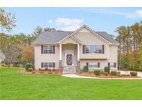 Two-story house with stone accents and a landscaped lawn at 6890 Fletcher Dr, Winston, GA 30187