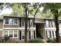 Attractive condo building with mature trees and landscaping at 5157 Roswell Rd # 9, Atlanta, GA 30342