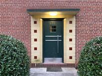 Green front door entrance with brick building and bushes at 1148 Briarcliff Ne Rd # 1, Atlanta, GA 30306