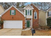 Brick two-story home with green door and attached garage at 485 Kensington Parc Dr, Avondale Estates, GA 30002