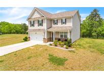 Two-story house with attached garage and landscaped front yard at 4929 Calgary Dr, Douglasville, GA 30135