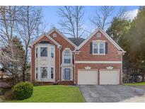 Brick house with three-car garage and landscaped lawn at 3680 Edenbourgh Pl, Marietta, GA 30066