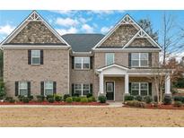 Two-story brick home with a front porch and landscaping at 3759 Chapel Cove, Douglasville, GA 30135