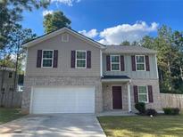 Two-story house with gray siding, white garage door, and burgundy shutters at 416 Robin Hill Ln, Temple, GA 30179