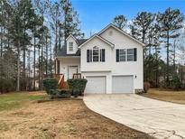 Two-story house with white siding, two-car garage, and a landscaped yard at 544 Eagles Nest Cir, Carrollton, GA 30116