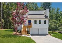 Newly renovated house with a two-car garage and landscaped lawn at 2909 Emerald Ln, Acworth, GA 30102