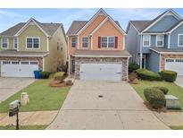 Two-story townhome with stone accents and a two-car garage at 7167 Rigel Sw Bnd, Atlanta, GA 30331