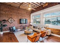 Spacious living area with exposed brick, hardwood floors, and large windows at 150 Walker Sw St # 5, Atlanta, GA 30313