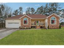 Ranch style home with stone accents and a landscaped lawn at 141 Hunters Way, Villa Rica, GA 30180