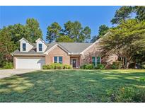 Brick house with a large front yard and a two-car garage at 1395 Fountain Cove Ln, Lawrenceville, GA 30043