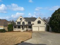 Two story house with a three-car garage and large front yard at 3714 Thunder Ne Way, Marietta, GA 30066