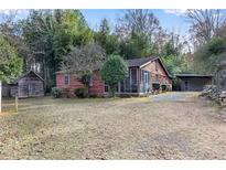 Rustic log cabin with screened porch and detached garage at 3953 Rhyne Se Way, Smyrna, GA 30082