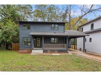 Charming two-story house with gray siding, front porch, and well-manicured lawn at 60 Rogers Se St, Atlanta, GA 30317