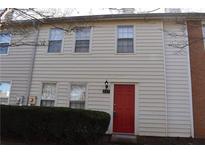 Tan two-story townhouse with red front door and landscaping at 237 Chads Ford Way, Roswell, GA 30076
