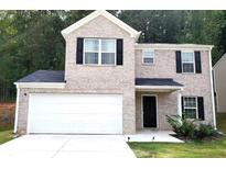 Brick two-story house with a white garage door and landscaping at 5626 Laurel Ridge Dr, Atlanta, GA 30344