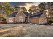 Ranch style home with stucco exterior, landscaped yard, and attached two-car garage at 20 Jasmine Ln, Oxford, GA 30054