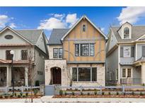 Two-story craftsman home with light brick and shingle accents at 107 Cumming St, Alpharetta, GA 30009