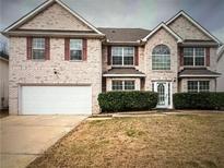 Brick two-story house with a large yard and a two-car garage at 2907 Chilhowee Dr, Atlanta, GA 30331
