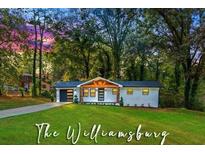 Newly renovated home with modern exterior and landscaped lawn at 2690 Williamsburg Dr, Decatur, GA 30034