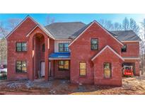 Brick two-story house with covered porch and large windows at 2977 N Bogan Ne Rd, Buford, GA 30519