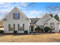 Attractive house with gray siding, landscaping, and a well-maintained lawn at 5642 Little Mill Pkwy, Buford, GA 30518