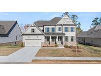 Two-story home with gray siding, stone accents, and a three-car garage at 739 Marlay Sw Ln, Powder Springs, GA 30127